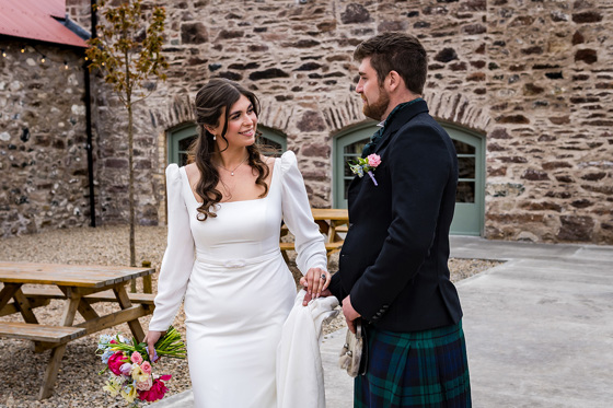 Bride and groom in courtyard of Kinclune Steading